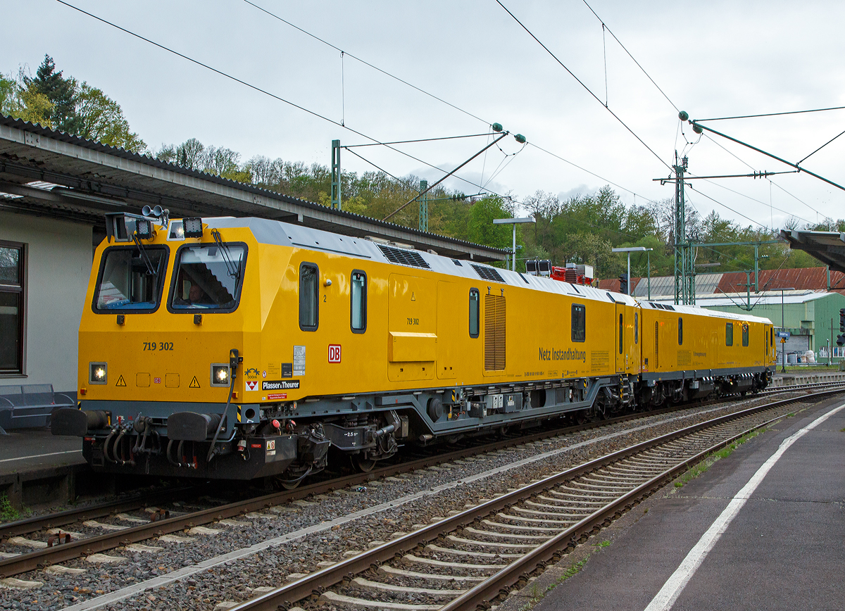 Glück für den Fotografen, das der Schienenprüfzug Hp 0 hatte....
Der Plasser & Theurer Schienenprüfzug (der Bauart SPZ 3) 719 302 / 720 302 (99 80 9160 005-1D-DB / 99 80 9360 008-3 D-DB) der DB Netz AG haete am 10.05.2021 im Bahnhof Betzdorf (Sieg) Hp 0, nun fährt er in Richtung Siegen weiter.

Der Schienenprüfzug wurde 2017 von Plasser & Theurer in Linz (A) unter der Fabriknummer 6048 (SPZ-STW) und  6049 (SPZ-ATW) gebaut.

Um Schäden am Oberbau frühzeitig zu erkennen, setzt die Deutsche Bahn AG verschiedene Prüfzüge der Baureihen 719 und 720 ein. Mittels zweier zerstörungsfreier Prüfverfahren werden die Schienen auf Schädigungen untersucht. Bei der Ultraschallprüfung können Materialfehler durch Materialermüdung innerhalb der Schiene bis zum Schienenfuß erkannt werden. Mit der Wirbelstromprüfung wird der Schienenkopf geprüft. 

Die Schienenprüfzüge der BR 719.3/720.3 wurden ab 2015  von Plasser & Theurer in Linz (A) gebaut. Diese dritte Messtriebwagengeneration entstand in modularisierter Bauweise. Sie basiert auf einer ein- und zweiteiligen Messwagenfamilie, die Ende 2012 von der DB bestellt wurde. Die Schienenprüfzüge sind zweiteilig ausgeführt und bestehen aus einem allachsgetriebenen Trieb- (ATW) und einem Steuerwagen (STW). Beide Wagen sind 23 Meter lang. Der ATW hat ein Eigengewicht von 81 t, der STW 67 t. Der Triebzug hat eine Höchstgeschwindigkeit von 140 km/h.
Unter dem Bodenrahmen des Steuerwagens sind zwischen den Drehgestellen ein absenkbarer Messwagen und zwei Wasserbehälter für die ZfP-Sensorik aufgehängt. Auf dem Dach des Triebwagens sitzt ein Messstromabnehmer. Als Antrieb dienen zwei Deutz-Dieselmotoren. Im hinteren Teil des Triebwagens gibt es eine klimatisierte Küche mit Mikrowelle, Herd, Spüle, Tisch und Sitzecke mit Wifi sowie eine Toilette. Im Steuerwagen sind neben dem Beobachtungsstand mit neun Monitoren eine Werkstatt mit Ersatzteillager und Kalibriergeräten, Schaltschränke mit Messtechnik, vier Schlafabteile und der Führerstand 1 untergebracht. Die Ultraschall- und Wirbelstrommesstechnik wurde von der Firma PLR Magdeburg geliefert. 